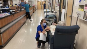 FILE - A nurse talks to a patient in the emergency room at Salem Hospital in Salem, Ore., on Aug. 20, 2021. Oregon voters are being asked in the November election to decide whether the state should be the first in the nation to amend its Constitution to explicitly declare that affordable health care is a fundamental human right.