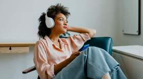 A woman wearing headphones. (Getty Images) 