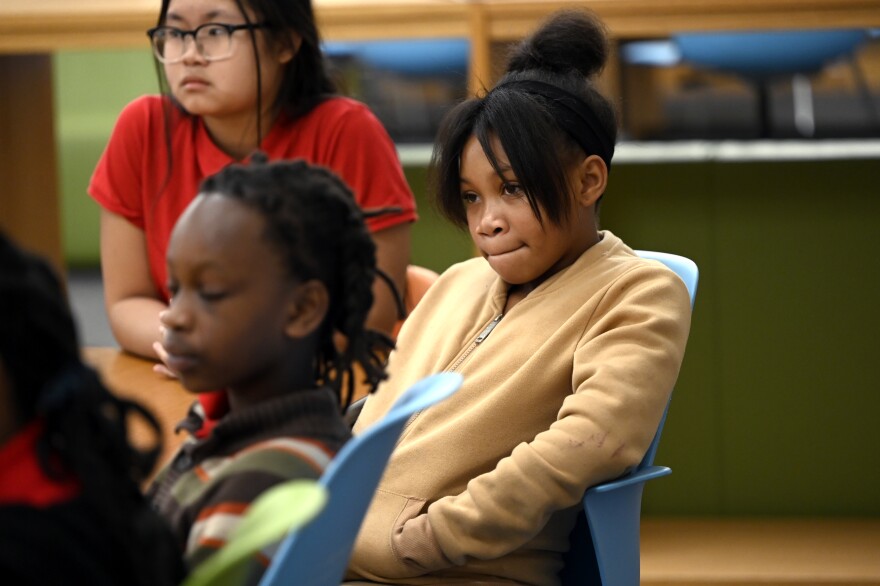 12 year old 7th grader Mioshi Fentress listens to U.S. Senator Chris Murphy (D-Conn.) after sharing here stories during a roundtable discussion with Alfred E. Burr Middle School students on youth mental health and ways to improve support services in schools i9n Hartford, Connecticut September 30, 2022.