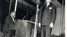 Pete Johnson playing piano and Big Joe Turner singing into a microphone onstage at Café Society in New York City. (Courtesy of the University of Missouri-Kansas City Libraries, Dr. Kenneth J. LaBudde Department of Special Collections)