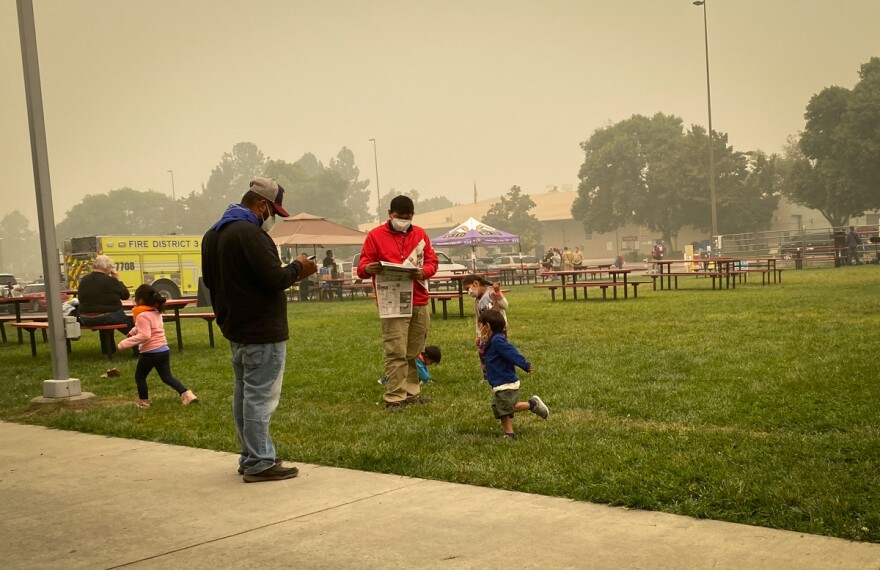  Families at the Jackson County Expo read the news on Sept. 9, 2020, the day after the Almeda Fire destroyed thousands of homes.