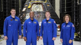Artemis II crew members, from left, Jeremy Hansen, Victor Glover, Reid Wiseman and Christina Koch, stand together at NASA's Kennedy Space Center in Florida, in front of an Orion crew module on Tuesday, Aug. 8, 2023. The U.S.-Canadian crew inspected the capsule during a visit late Monday and Tuesday. NASA plans to send the four around the moon and back late next year. (Kim Shiflett/NASA via AP)