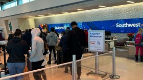 Southwest Airlines passengers at Dallas Love Field Airport wait in line to rebook cancelled flights.