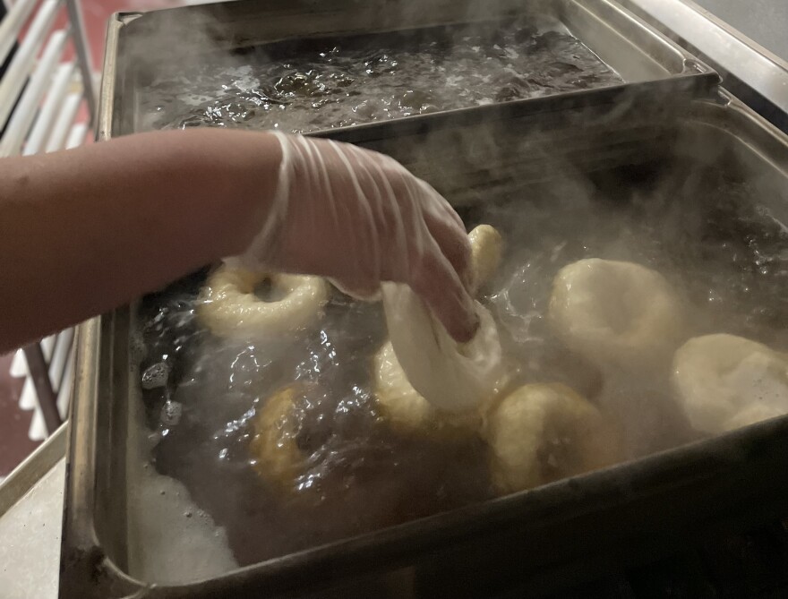 Bagels going into boiling water