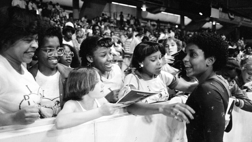 FILE - In this June 5, 1983, file photo, Dianne Durham, right, of Gary, Ind., gives autographs after winning the women's title at the McDonald's U.S.A. Gymnastic Championships at the University of Illinois in Chicago. Durham, the first Black woman to win a USA Gymnastics national championship, died on Thursday, Feb. 4, 2021, She was 52.