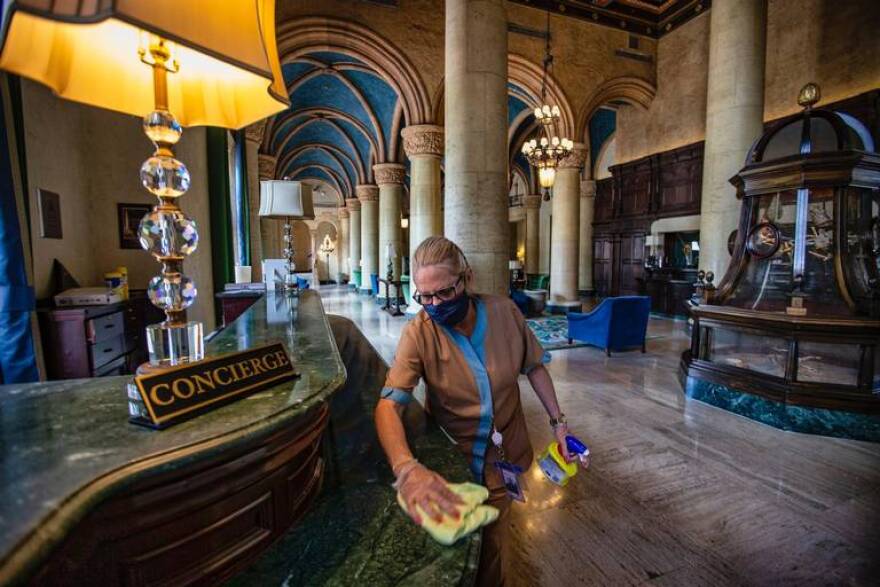 Hotels in South Florida were shutdown for about three months. Hoteliers say the rebound will initially rely on Americans vacationing to the region. The Biltmore lobby in Coral Gables gets a cleaning on May 29, 2020.