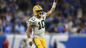 Green Bay Packers quarterback Jordan Love runs up field after throwing a touchdown to wide receiver Christian Watson during the second half of an NFL football game against the Detroit Lions, Thursday, Nov. 23, 2023, in Detroit. (AP Photo/David Dermer)