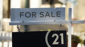 A for sale sign stands outside a single-family home on the market late Friday, Oct. 27, 2023, in Denver.