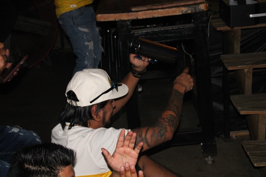 A Colombia fan brought a güira to Friday's watch party, playing along to the DJ's music.