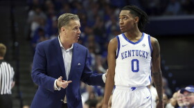 Kentucky's head coach John Calipari, left, talks to Rob Dillingham (0) during the second half of the team's NCAA college basketball game against Vanderbilt on Wednesday, March 6, 2024, in Lexington, Ky. (AP Photo/James Crisp)