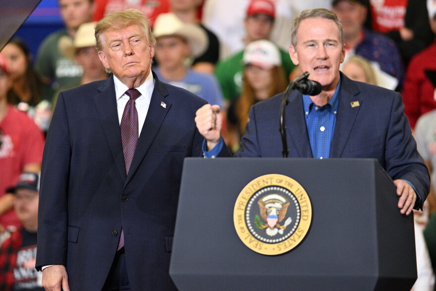 President Donald Trump listens as Sen. Jon Husted, R-Ohio, speaks at a campaign rally at the Shoemaker Center at Ohio University Chillicothe in Chillicothe, Ohio, Wednesday, Oct. 28, 2026. (AP Photo/Jon Cherry)