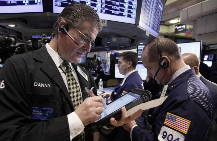 Daniel Kryger, left, works with fellow traders on the floor of the New York Stock Exchange. If the European Union can't agree on a plan, its debt crisis could lead to the kind of financial chaos that economists say surely would hurt the United States.