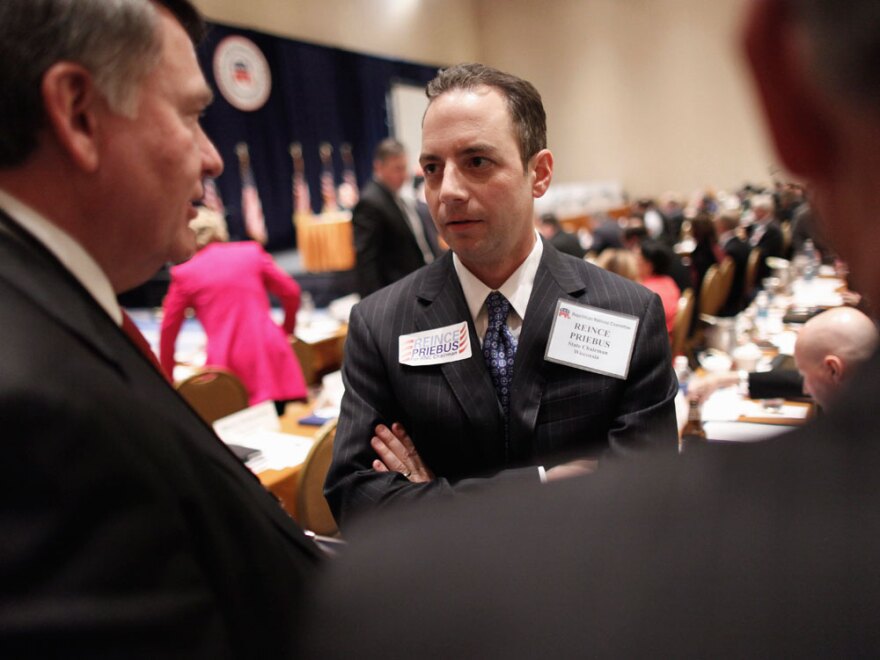 Reince Priebus talks with members during the Republican National Committee meeting on Friday in Oxon Hill, Md. Priebus was selected as RNC chairman after seven rounds of voting.