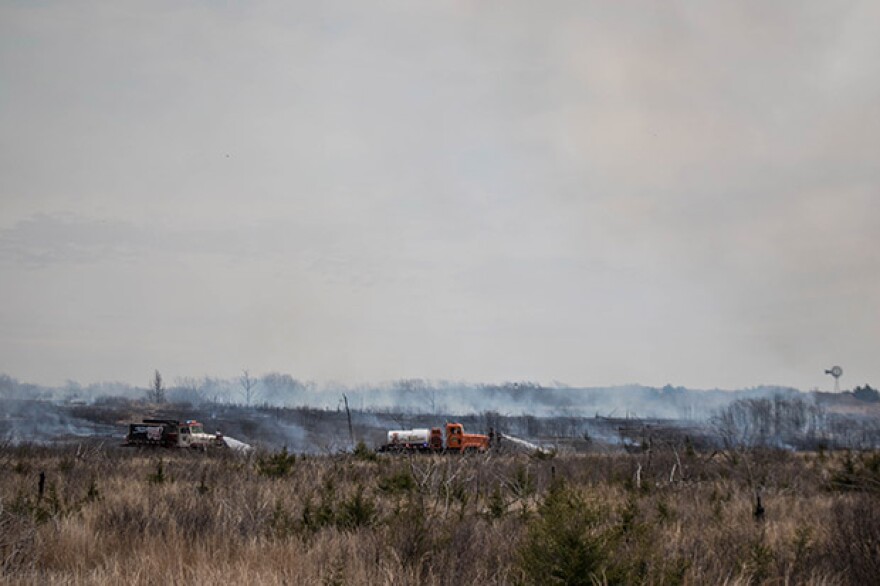 Fire crews work to reduce wildfire danger by clear brush through a prescribed burn in northwestern Oklahoma in April 2016.