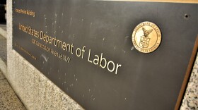 A placard in front of the U.S. Department of Labor. A proposed mandate would have Occupational Safety and Health Administration enforce a requirement that businesses with 100 or more employees be vaccinated or get tested weekly.