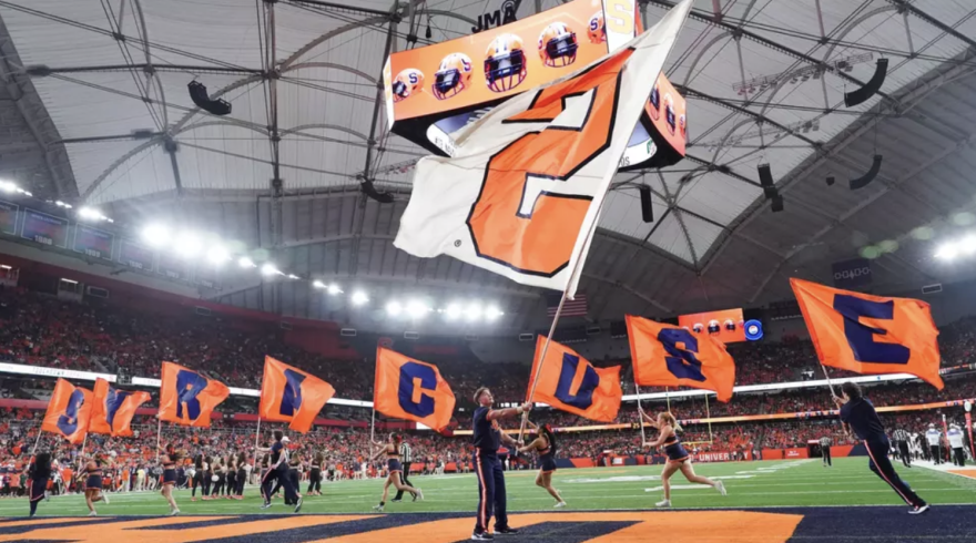 Syracuse Cheer team celebrating an Orange touchdown