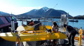 Mechanical engineer, June Marion, works on the kayak’s engine assisted by her dad, Bobby Brown. Working on the rear kayak is robotics science students, Nick McComb and Corwin Perren. (Photo/Angela Denning)