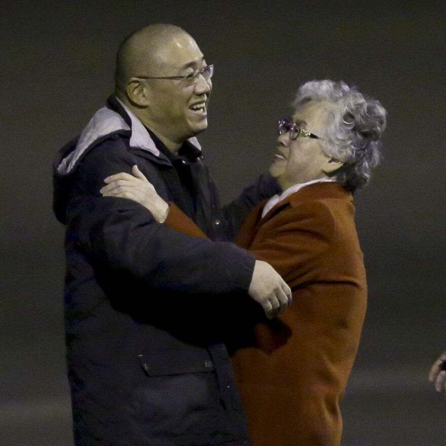 Kenneth Bae greets his mother, Myunghee Bae after arriving Saturday in Washington.