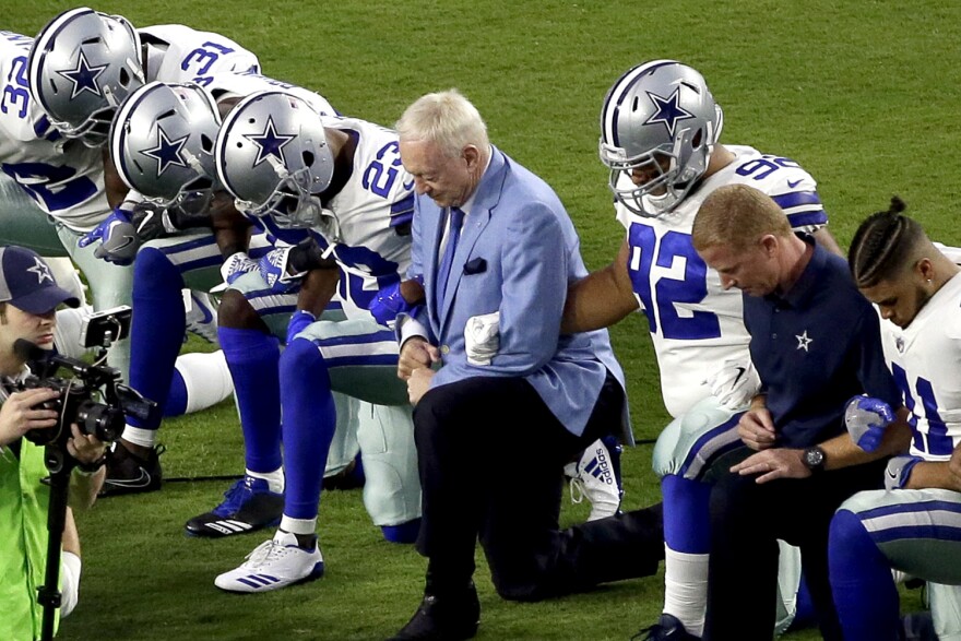 In this Monday, Sept. 25, 2017 file photo, the Dallas Cowboys, led by owner Jerry Jones, center, take a knee prior to the national anthem prior to an NFL football game against the Arizona Cardinals, in Glendale, Ariz.  (Matt York/AP)