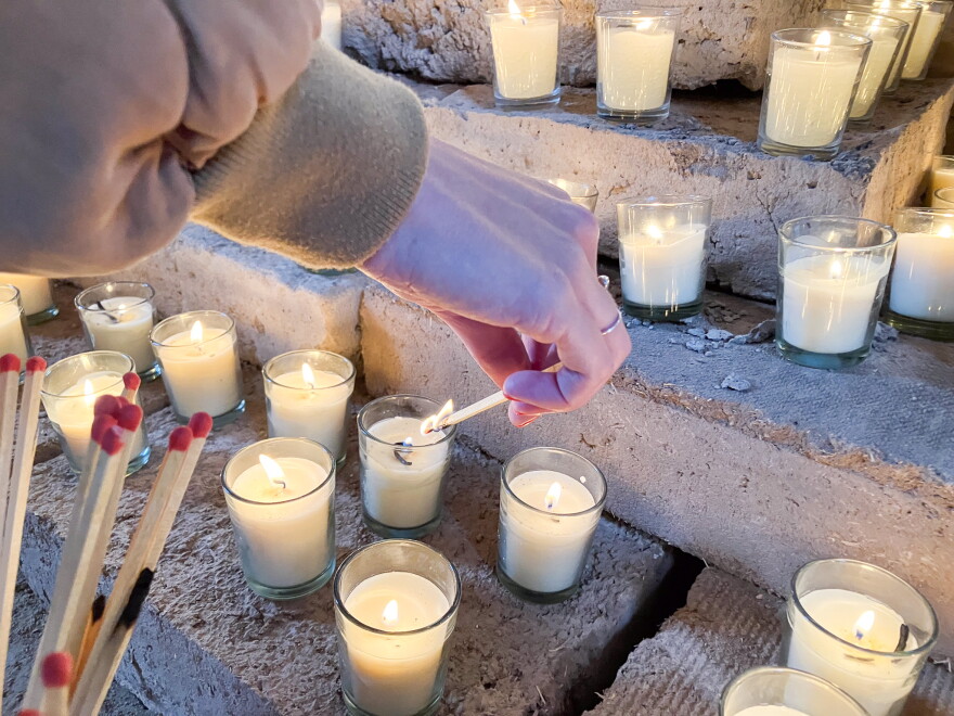Dozens of candles were lit on an alter honoring the returned church bell — which was the focus of the days celebration.