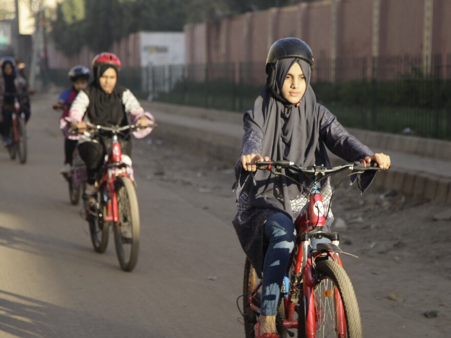 Zulekha Dawood leads female cyclists through a neighborhood in Karachi, Pakistan. They ride early in the morning to avoid the worst of traffic.