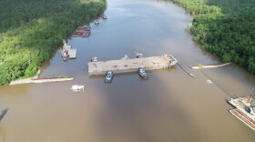 Crews move a barge into place on Bayou Chene near Morgan City. The state built the temporary structure at the height of flood concerns in the summer of 2019.