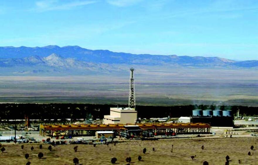 Photo of a geothermal plant in Utah with mountains in the distance.