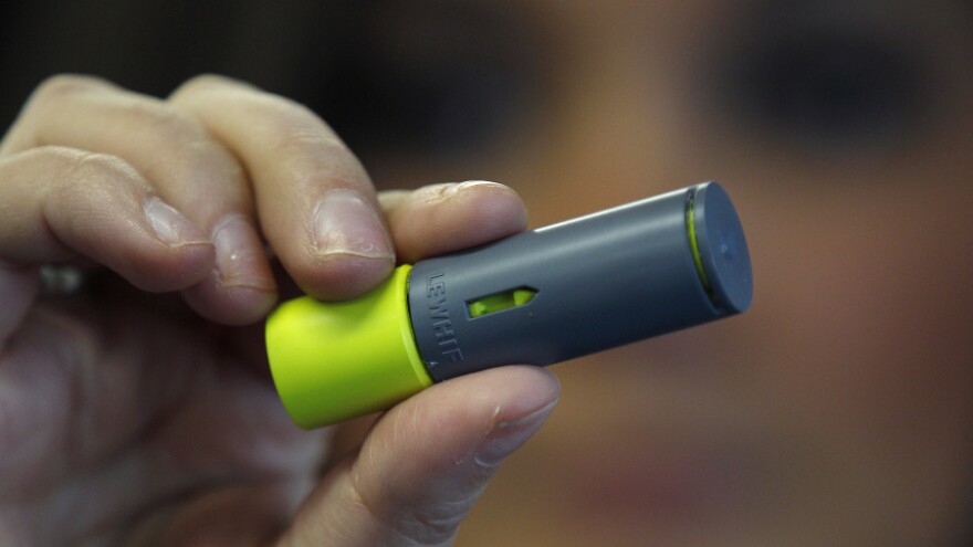 A woman holds an AeroShot inhalable caffeine device in Boston.
