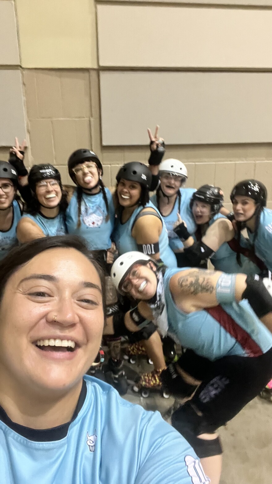 Kristina Glass takes a picture with members of Indigenous Rising Roller Derby.