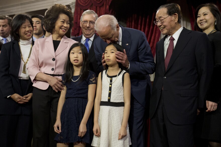 Biden kisses a niece of Senate Majority Leader Mitch McConnell, R-Ky., during a ceremonial Senate swearing-in ceremony on Capitol Hill in 2015.