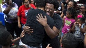 Mike Hassell, of the Chosen for Change foundation, hugs Joshua Anderson, of the Get Fit Crew, after a dance-off at a party to celebrate what would’ve been Mike Brown’s 20th birthday on May 20, 2016 at Canfield Green Apartments.