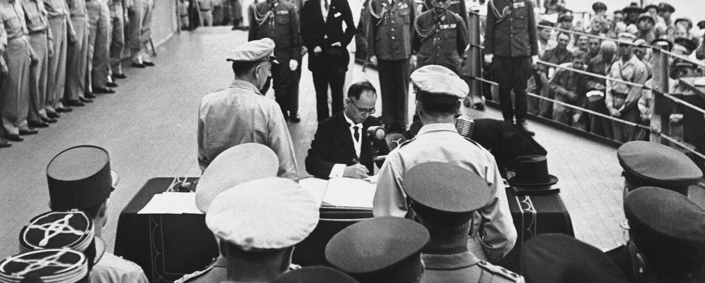 FILE- In this Sept. 2, 1945, file photo, then Japanese Foreign Minister Mamoru Shigemitsu signs Japanese Instrument of Surrender, a document signed on the deck of the USS Missouri in Tokyo Bay, Japan.