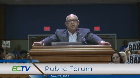 Chris Plate', Chief Executive Officer FloridaWest Economic Development Alliance, spoke during the Public Forum. He said negotiations are not happening to bring data centers to Escambia County. Several attendees held up signs of protest. 