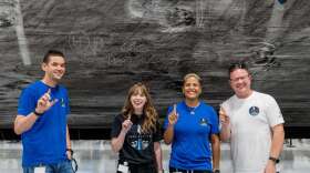 The crew of Inspiration4 signs the soot in the Falcon 9 rocket booster that will launch them into space. Photo: Inspiration4 / John Kraus