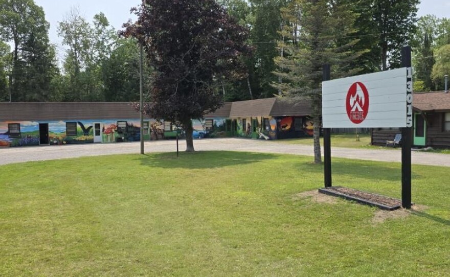 The panoramic mural on the outside of the Fireside Lodge in Atlanta showcases parts of Michigan culture and takes inspiration from the natural world
