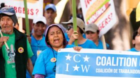 Antonia Rios chants with protestors from the front of the pack. The Mexico native says that workers don't get paid for the hours they spend waiting for — and traveling in — the bus that takes them to work. Rios moved to the United States in 1999 and began picking tomatoes in 2002; she also works as a volunteer at her daughters' school. (Photos by Justin Bright/WUFT News)