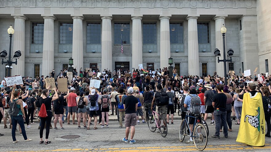 Protesters gathered in front of Central Library Wednesday night before marching through downtown to Monument Circle.