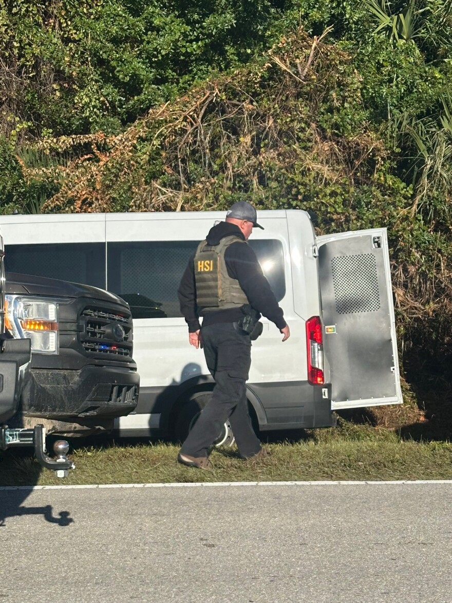 An agent from the U.S. Homeland Security, a federal law enforcement agency within the U.S. Department of Homeland Security, in Immokalee Wednesday morning. Workers on a tomato grower's bus were reportedly taken off the vehicle. An immigration support group, Unidos Immokalee, said several workers were in need of medical attention after they were removed from the bus.