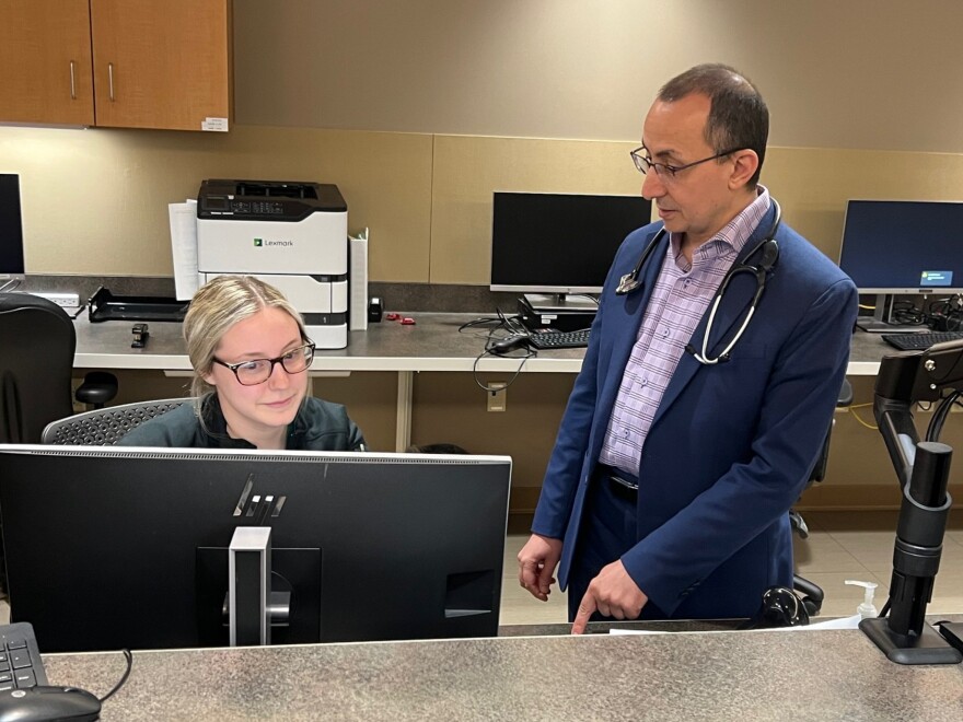 SIH Prairie Heart Institute Director of Cardiovascular Services Dr. Raed Al-Dallow consults with SIH Prairie Heart Institute nurse Alexia Boyd.