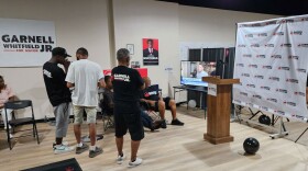 Supporters of Garnell Whitfield, Jr.'s mayoral campaign watch election results on a TV at his campaign headquarters.