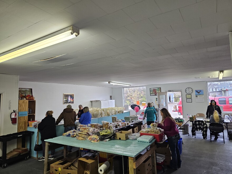 People pick up meal baskets during the pantry’s final food distribution before Thanksgiving