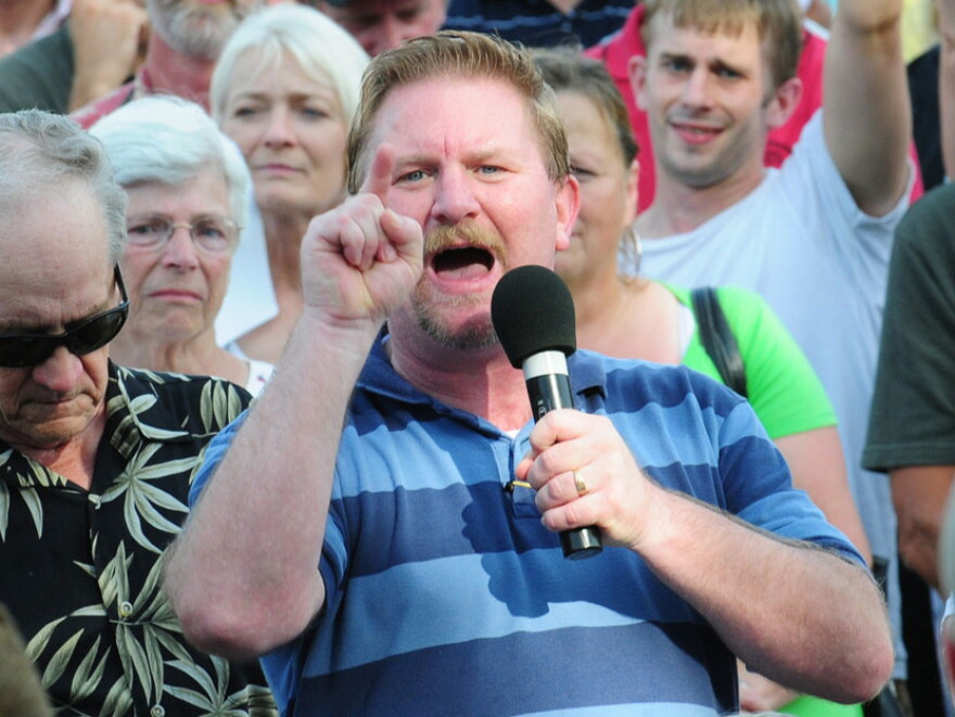 Brett Wian poses a question to Grassley at the town meeting in Adel. The senator, who is up for re-election next year, has been sharply criticized by conservative constituents and pundits for his efforts to reach across the aisle.