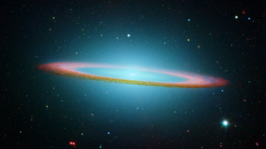 An image of the Sombrero galaxy, created from composite photos of the NASA/ESA Hubble Space Telescope and NASA's Spitzer Space Telescope.