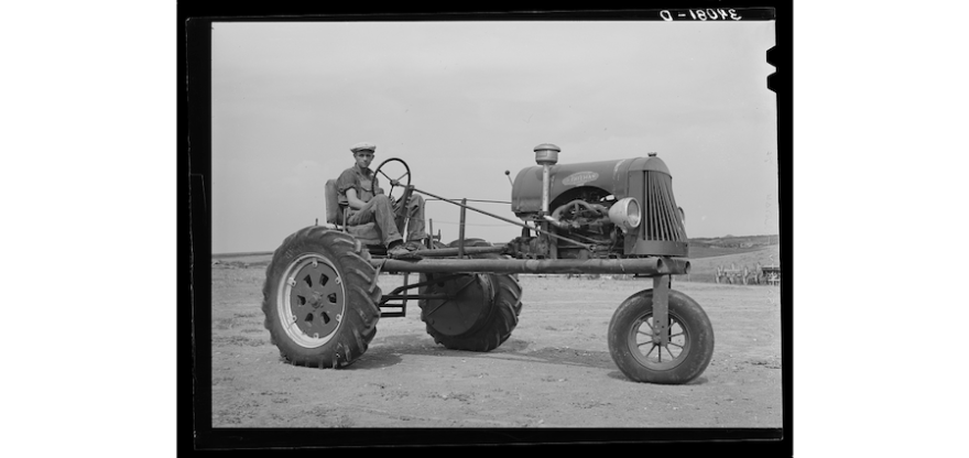 A farmer in Sheridan County, Kansas sits on his tractor, 1939.