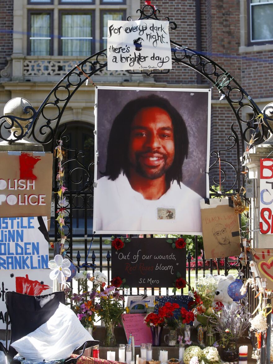 A photo of Philando Castile is attached to the gate of the governor's residence in St. Paul, Minn., part of a memorial to the Minnesota man, who was shot and killed by a police officer in July 2016.