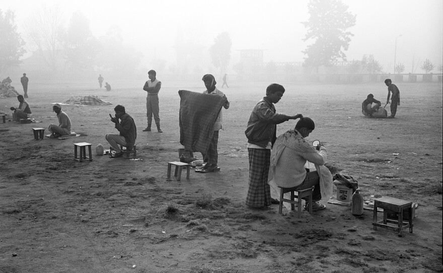 Early-morning, open-air haircuts were a Nepali tradition in 1989, when this photo was taken. The stretch of open green in the city of Kathmandu, called Tundikhel, is now reportedly a camping ground for earthquake survivors.