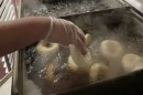 Bagels going into boiling water