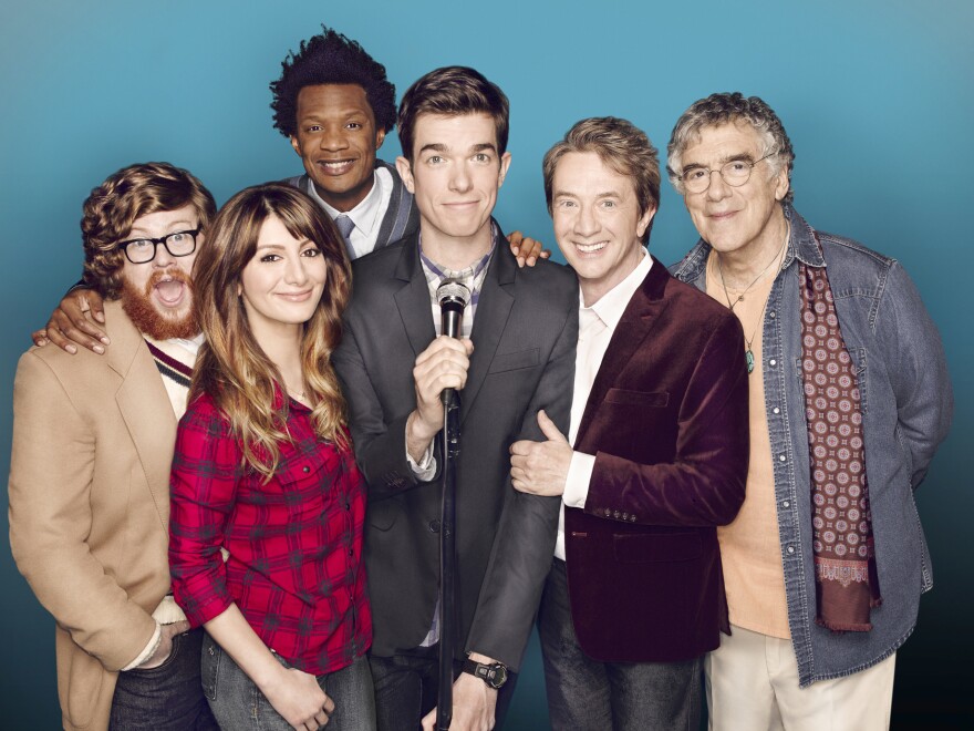 Comedian John Mulaney (center) stars with Zack Pearlman (from left), Nasim Pedrad, Seaton Smith, Martin Short and Elliott Gould on the Fox sitcom <em>Mulaney</em>.