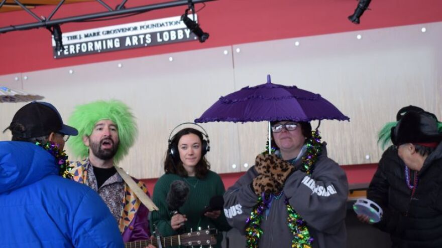 A group of people celebrates Mardi Gras.