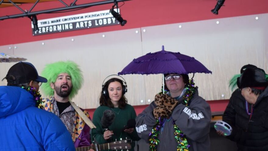 A group of people celebrates Mardi Gras. 